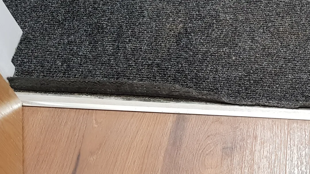 Carpet was not glued to floor under the front door